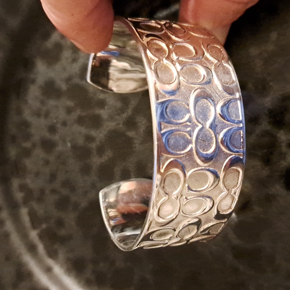 Gently worn COACH silver plated cuff bracelet. 1" wide.